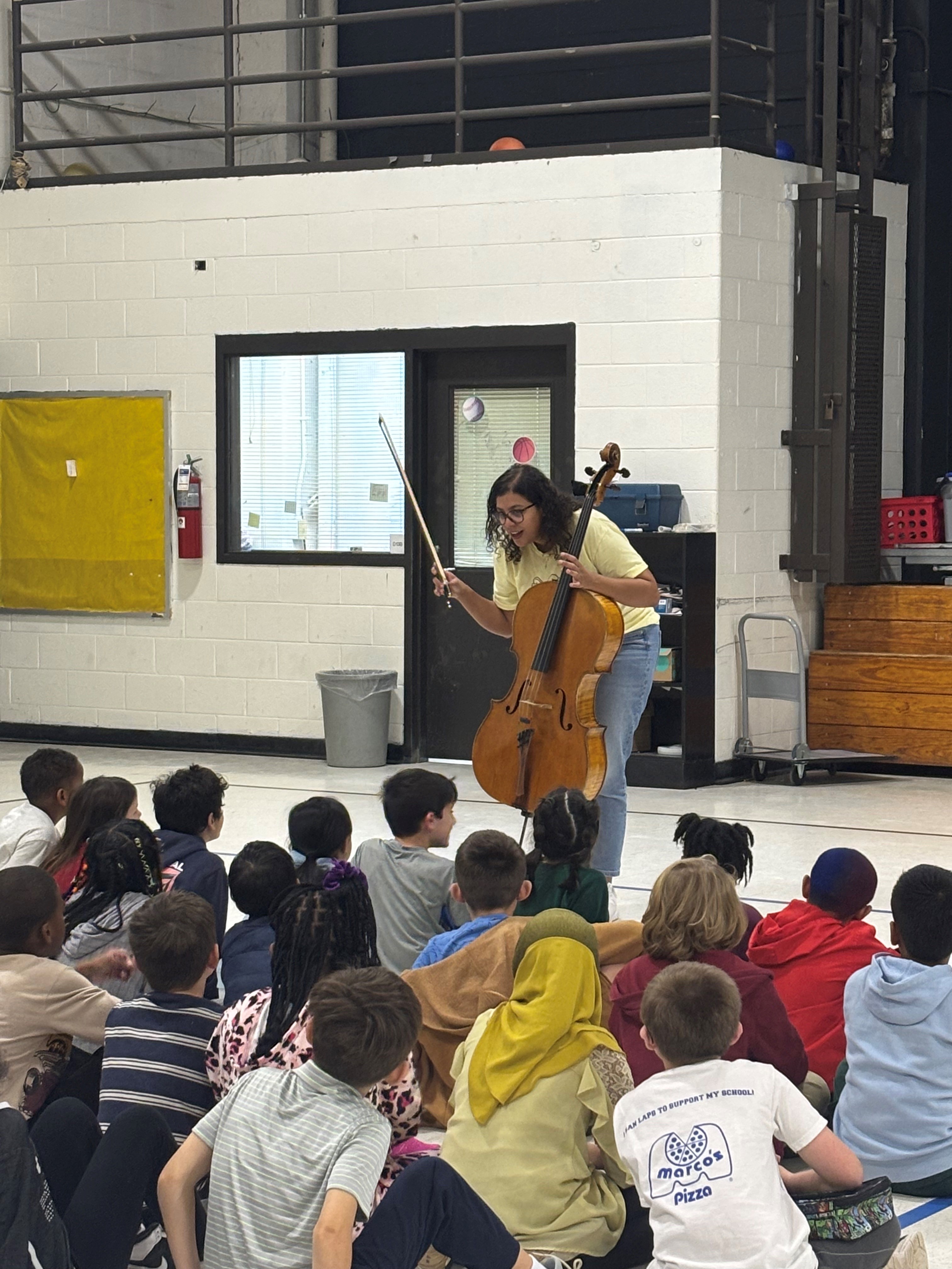 Musician teaching music to school students.